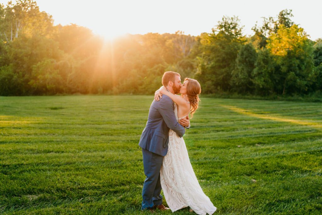 golden-hour-field-elopement-virginia.jpg Couple kissing at sunset in an open grassy field during their golden hour Virginia elopement