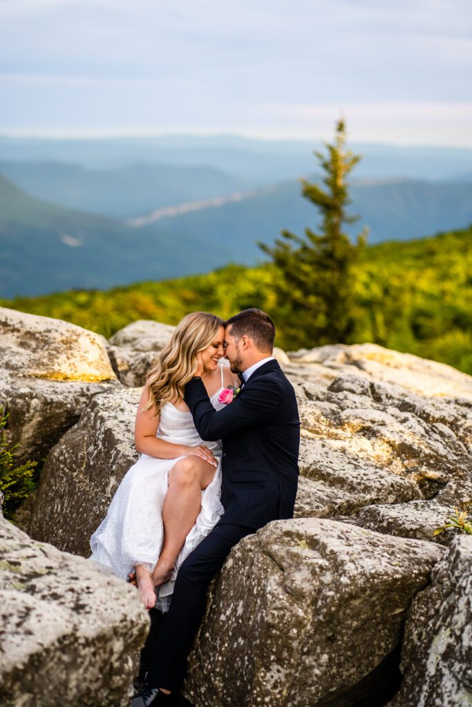 Couple shares an intimate moment at sunset in the middle of green forest brush during their West Virginia elopement in Dolly Sods West Virginia.