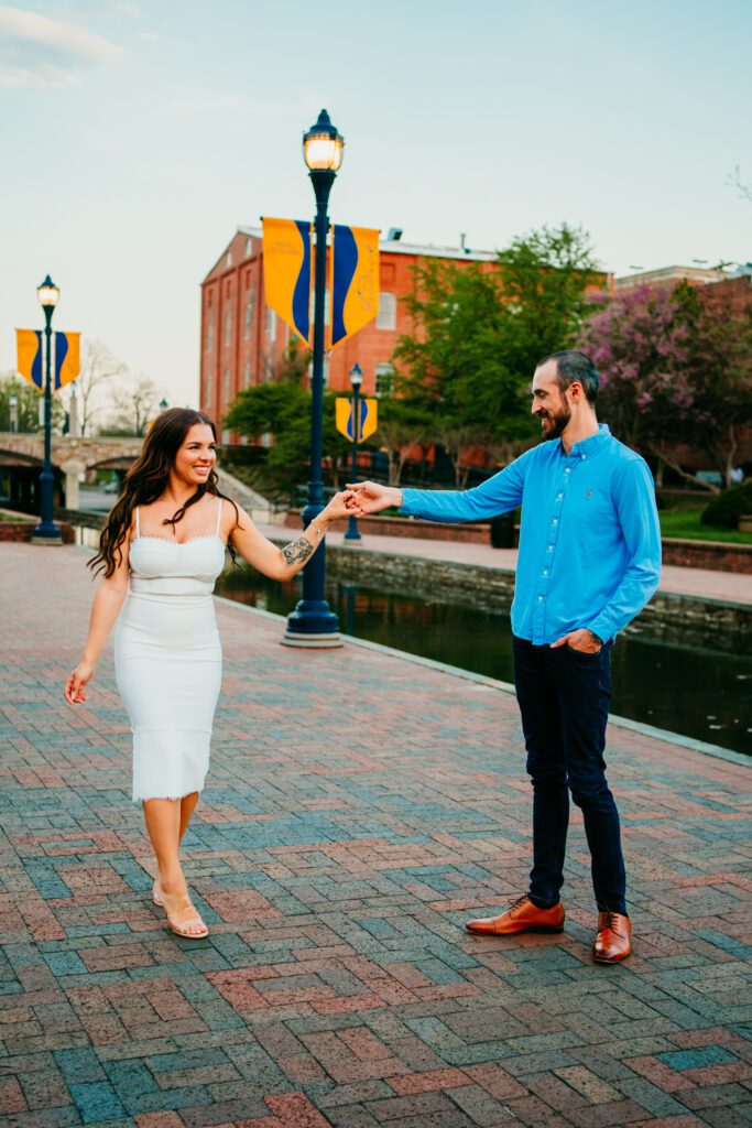 Couple dancing on the brick walkway at Carroll Creek Park during their Frederick MD engagement session